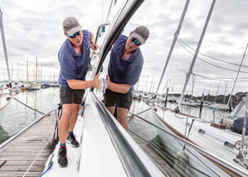 Reflection in the window of a yacht being valeted