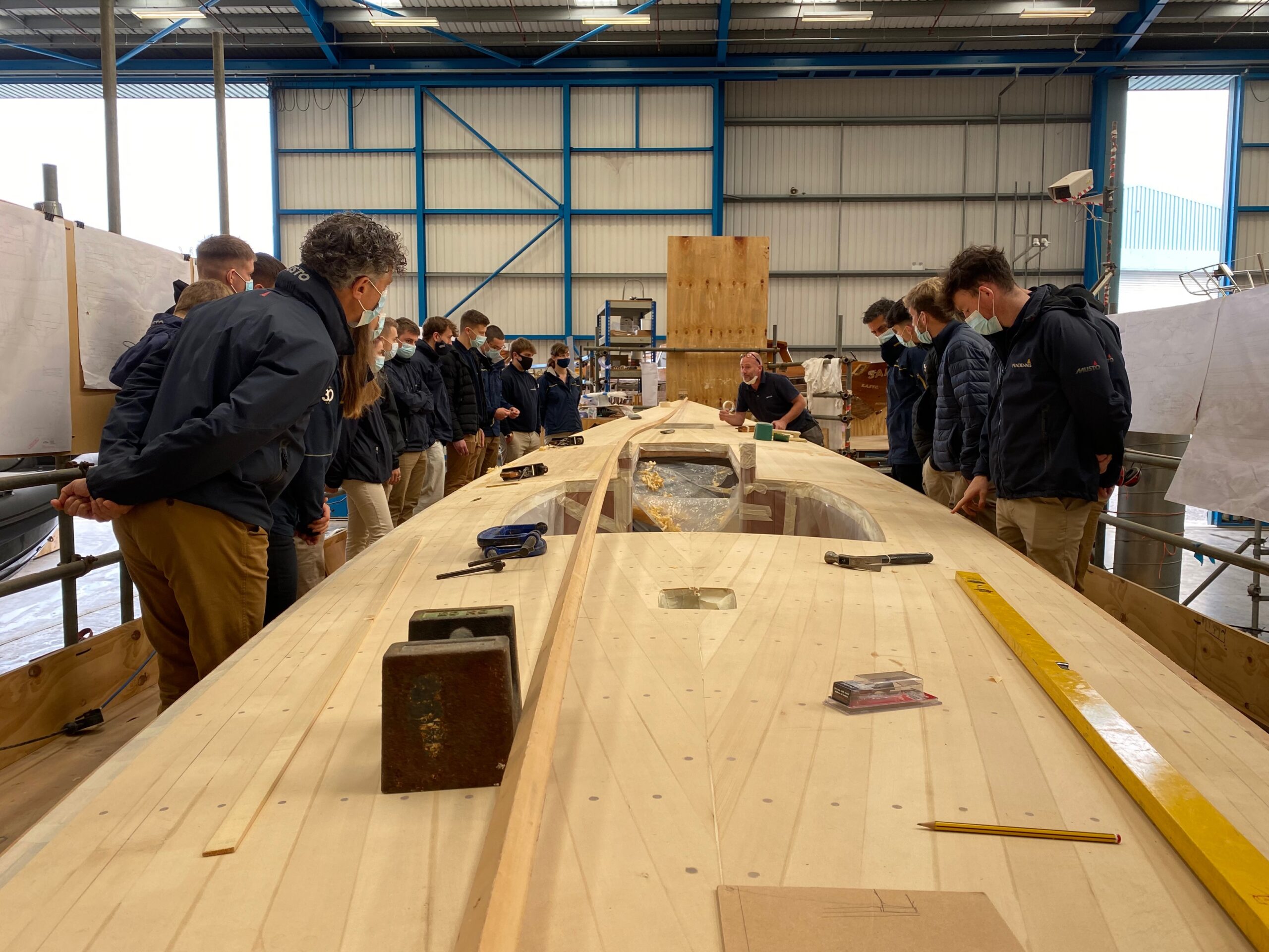 Pendennis Apprenitces around wooden boat RIPPLE