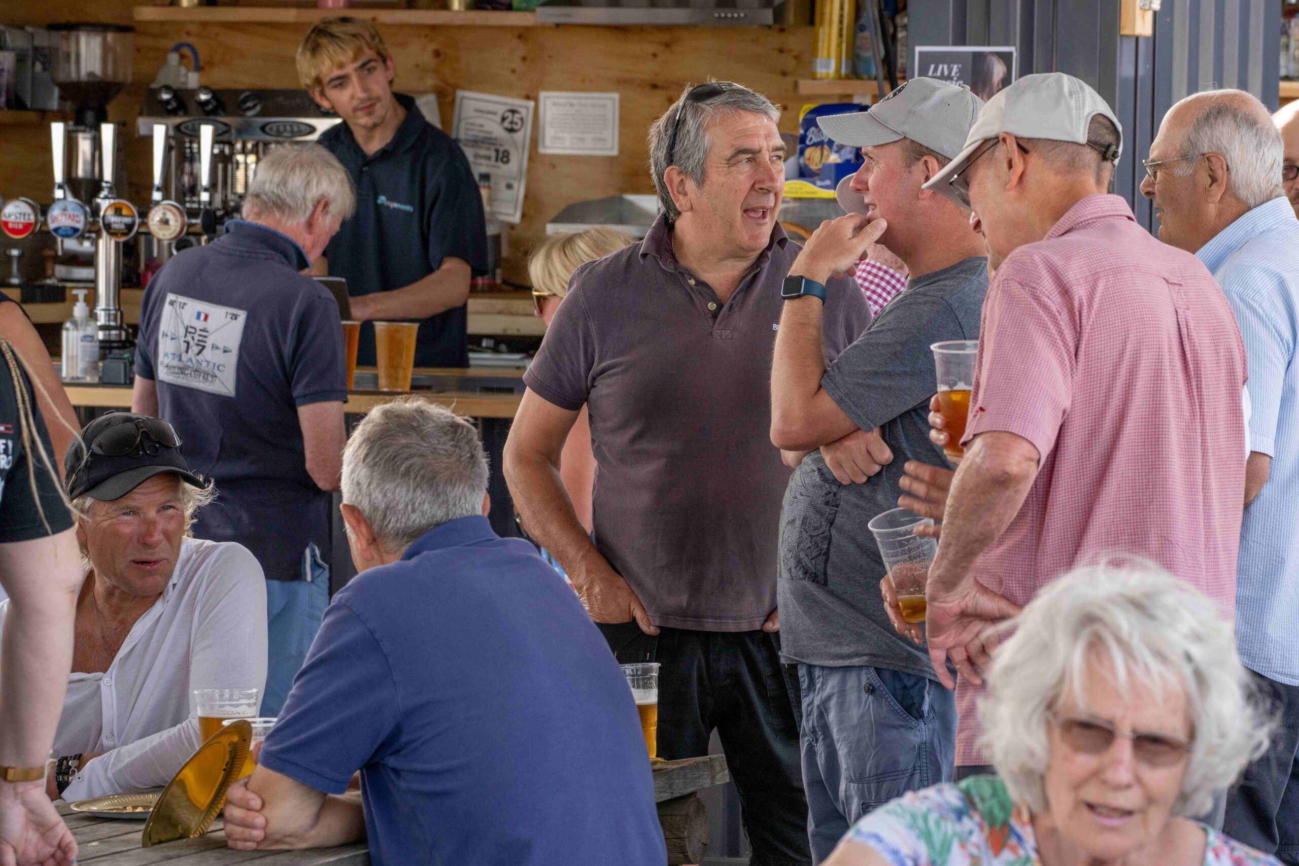 Berthon employees enjoying the sun and some drinks at Lymington Marina, for Dave Street's retirement party celebrating 50 years of service.